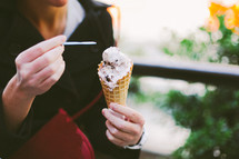 a woman eating a waffle cone 