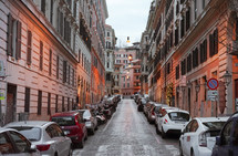 small cars parked along a narrow street in Rome 