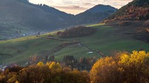 Vivid autumn colors of rural countryside landscape at sunny evening sunset with foggy clouds in valley Time-lapse
