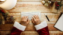 Santa Claus typing and working for Christmas 