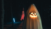 Ghost With Halloween Pumpkin In The Night Forest With Halloween Pumpkin