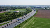 Aerial view of road interchange or highway intersection with busy urban traffic. 
