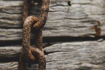 rusty chain on wood 
