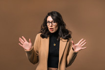 Mature woman afraid something, shock on beige backdrop. Unbelievable, bad news.