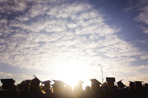sunlight shining on the heads of graduates 