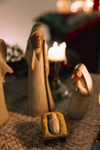 Nativity set surrounded by candles.
