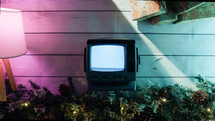 Colorful composition of old static tv and christmas decorations