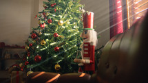 Nutcracker against On the side of Christmas tree