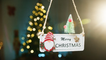 Merry Christmas sign moving and floating with tree background 
