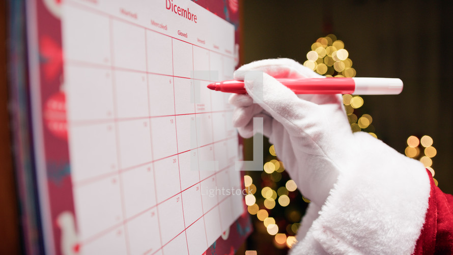 Santa Claus Marking Christmas Holidays on Calendar