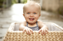 Happy toddler girl in basket