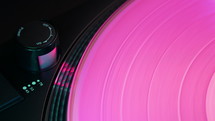 Colored pink vinyl record, turntable. Retro vibes.  Vintage aesthetics. Macro dynamic motion. Iconic imagery. High quality 4k footage
