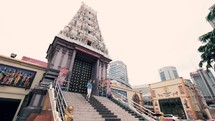 a woman walking down temple steps 