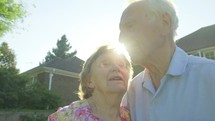 elderly couple standing outdoors 