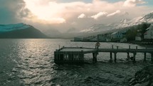 docks and homes along a shore and view of snow capped mountains 
