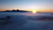 Beautiful light of sun over foggy alps mountains nature landscape in summer morning Aerial view
