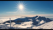 Sunny panorama of winter alps mountains nature with fast misty clouds Time lapse frozen landscape
