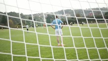 soccer game through a soccer net