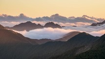 Epic evening with clouds in foggy mountains nature in New Zealand wild landscape at sunset Time lapse
