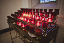 Tiered rows of votive candles 