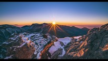 Winter is coming, beautiful sunset in alps mountains nature evening landscape with first snow on rocky peak Time-lapse 4K
