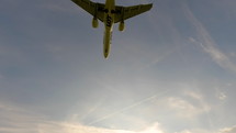 Overhead flying aircraft landing at sunset. Modern large plane flies overhead. 