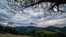 Dramatic clouds motion in countryside nature landscape in autumn evening, View under tree branches Time lapse
