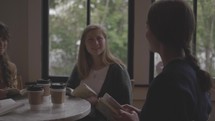 teen girls reading Bibles together over coffee 