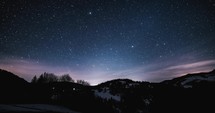 Magic winter night sky with stars of milky way galaxy motion fast before sunrise Time lapse Astronomy
