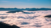Time lapse of Foggy clouds flows like a river in misty mountains nature
