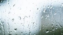 Timelapse of raindrops falling on glass
