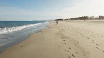 Man Sport Running On The Beach Near The Ocean Water In Calabria