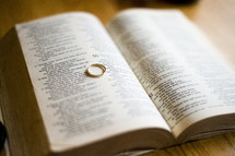 wedding band on the pages of a Bible