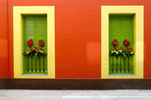 closed green shutters on a red house