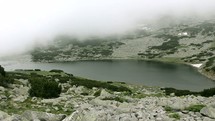 aerial view over a foggy mountain lake 