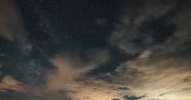 Milky way galaxy stars and clouds moving fast in summer night sky Timelapse background
