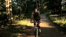 man riding a bicycle on a trail 