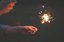 hand holding a sparkler 