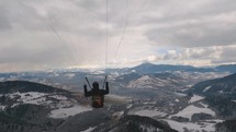 Paragliding turn above winter forest mountain, Freedom Fly adrenaline adventure Follow cam
