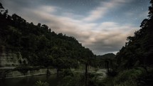 Clouds sky moving fast over Whanganui river in dark starry night nature in New Zealand Time-lapse
