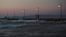 People on pier in the windy evening