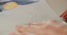 Close up of an artist drawing with colored pencils