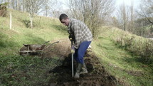 a man digging in a garden 