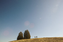 distant couple dancing on a hill