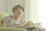 Senior caucasian woman reading a book themes of retired pensioner reading hobbies