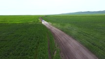 Car driving in field aerial view	