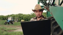Smart farming. Applying modern technology in agricultural activity. Young landowner with computer work. Concept modern technology.