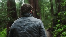 a man hiking on a forest trail 