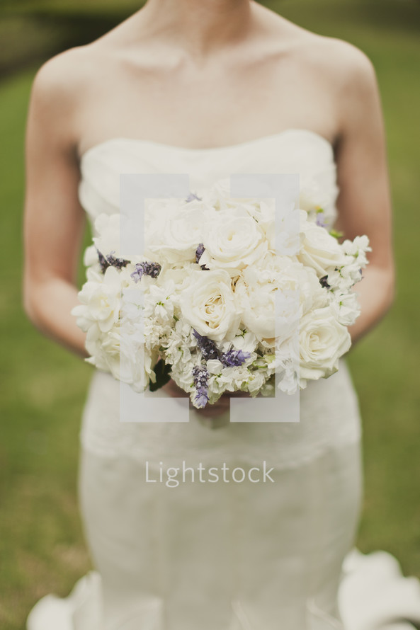 A bride holds her bouquet of flowers