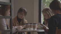 teen girls reading Bibles over coffee 